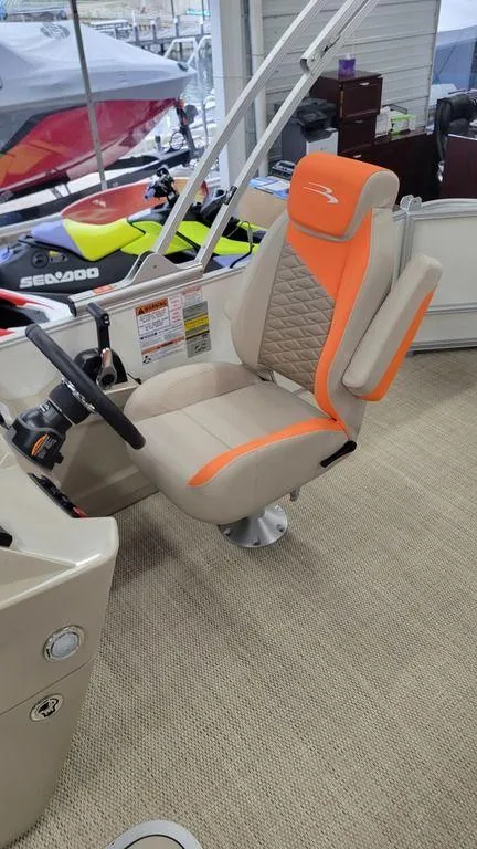 Slide: The Image of 2024 Bennington 20 SL boat captain's chair with orange and beige upholstery. - 4