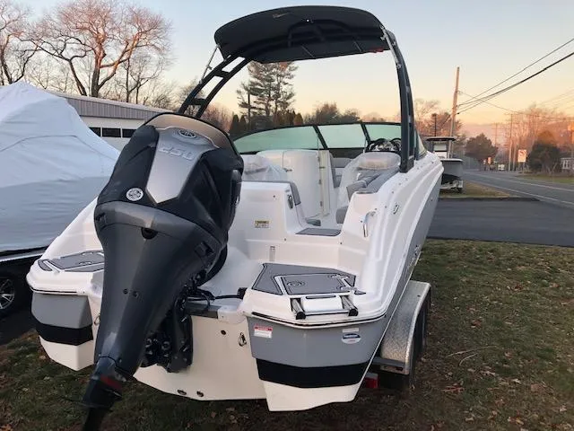 Slide: The Image of 2023 NauticStar 243DC Sport Deck boat with outboard motor on trailer. - 3