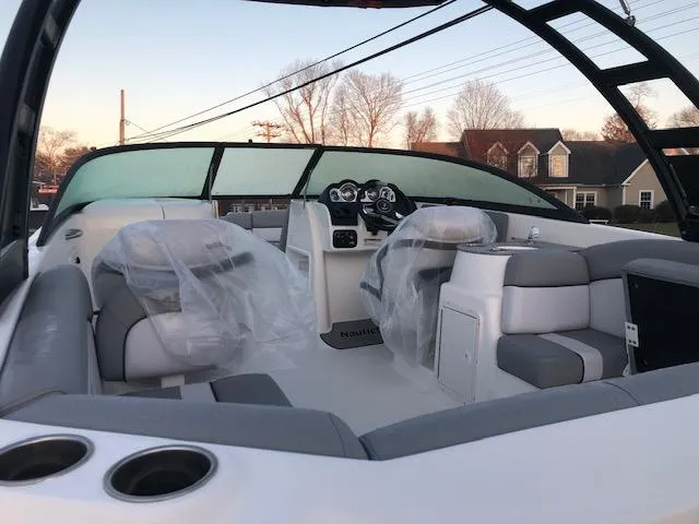 Slide: The Image of 2023 NauticStar 243DC Sport Deck boat interior with seating and dashboard. - 4