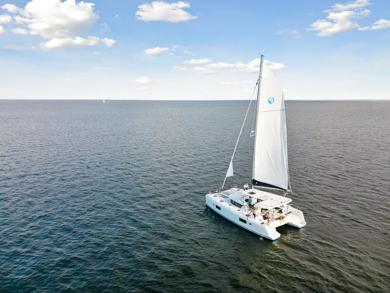 Slide: The Image of Lagoon 42 catamaran sailing on open water under a clear sky, 2018 model. - 11