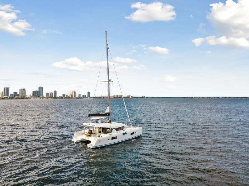 Slide: The Image of 2018 Lagoon 42 catamaran sailing near city skyline on a sunny day. - 13