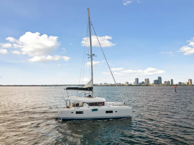Slide: The Image of Lagoon 42 catamaran sailing near city skyline, 2018 model. - 3