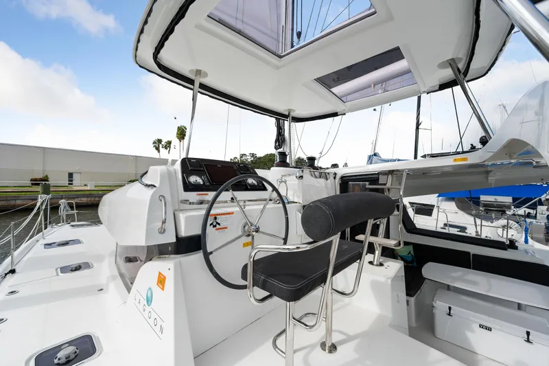 Slide: The Image of Lagoon 42 2018 model yacht cockpit with steering wheel and navigation controls. - 31
