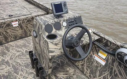 Slide: The Image of 2024 Crestliner 1660 Retriever SC boat console with camouflage design and steering wheel. - 13