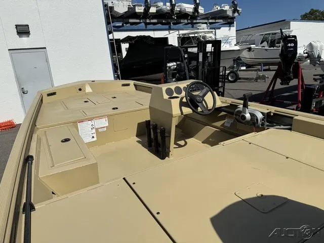 Slide: The Image of 2024 Crestliner 1660 Retriever SC boat, beige interior, steering console, docked at marina. - 6