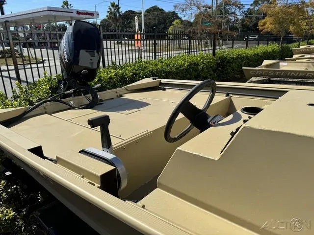 Slide: The Image of 2024 Crestliner 1660 Retriever SC boat with steering wheel and motor, parked outdoors. - 7
