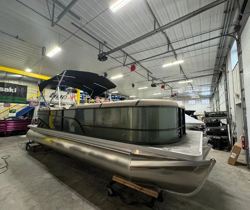 Slide: The Image of 2024 Crest Classic LX 240 pontoon boat in a warehouse. - 0