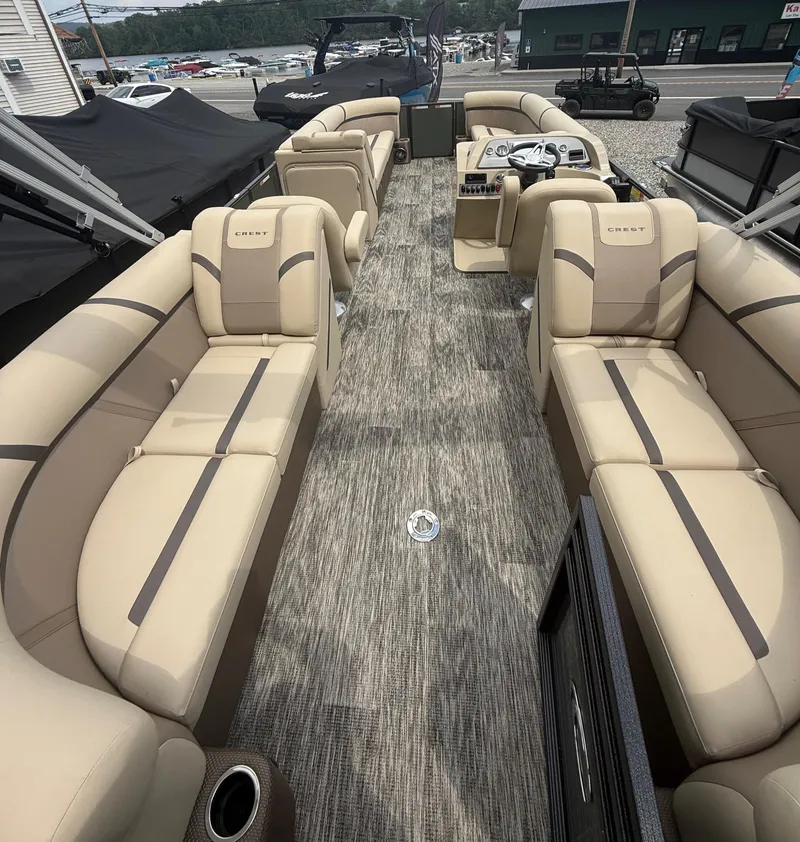 Slide: The Image of 2024 Crest Classic LX 240 pontoon boat with beige seating and modern interior design. - 11