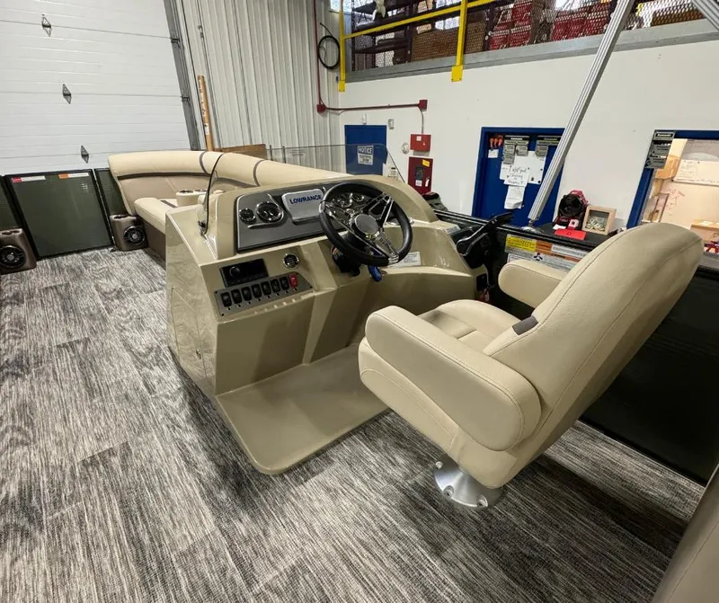 Slide: The Image of 2024 Crest Classic LX 240 boat interior with beige seating and modern controls. - 4