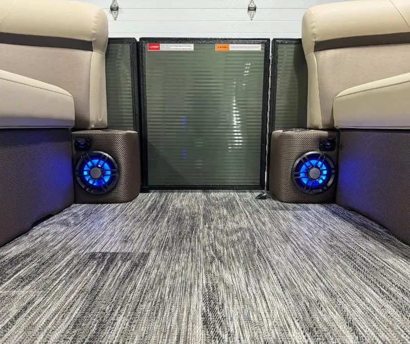Slide: The Image of 2024 Crest Classic LX 240 boat interior with blue LED speakers and plush seating. - 7