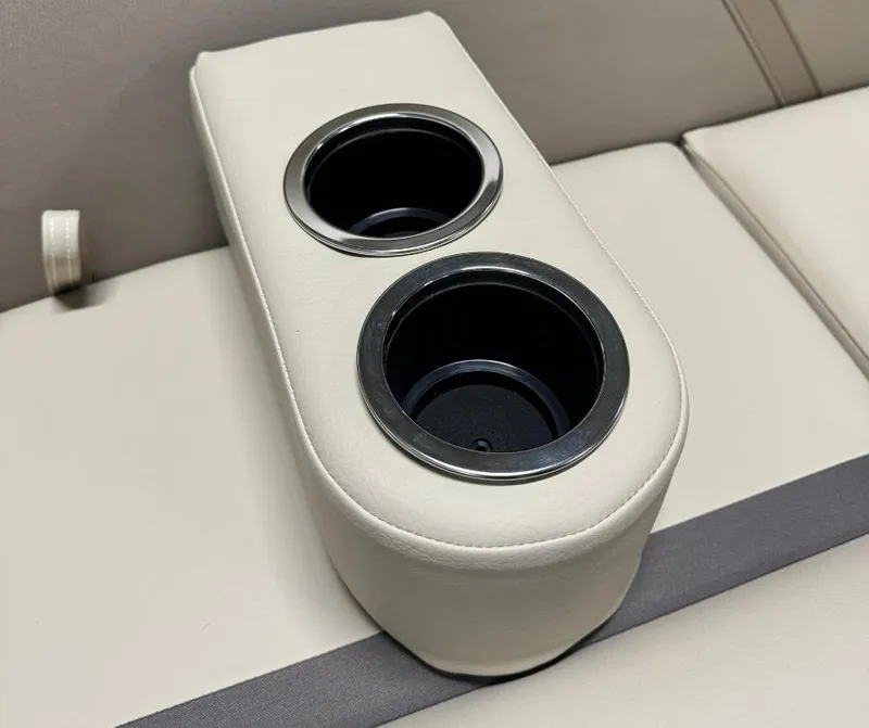 Slide: The Image of 2024 Crest Classic LX 240 boat interior with dual cup holders. - 8