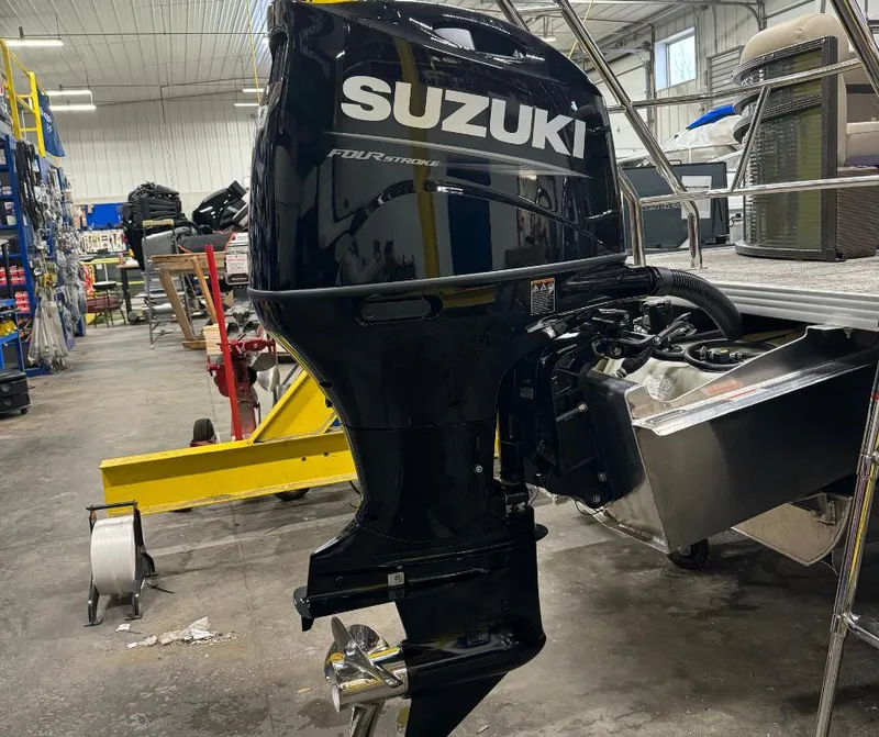 Slide: The Image of Suzuki outboard motor on a 2024 Crest Classic LX 240 boat in a workshop. - 9