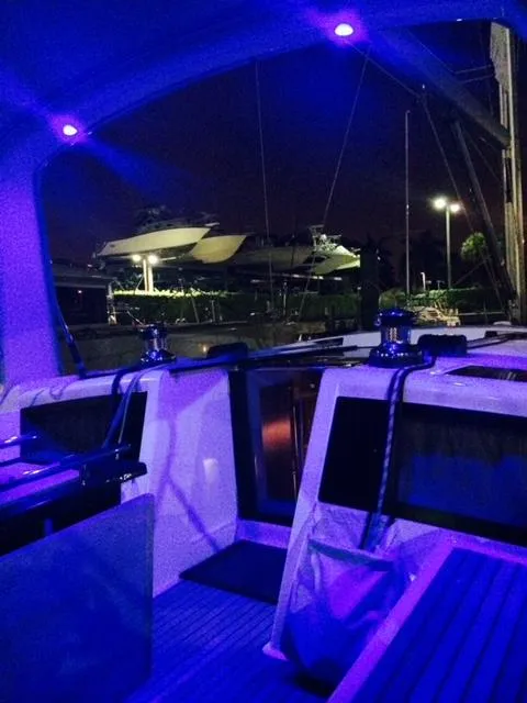 Slide: The Image of 2012 Beneteau Oceanis 48 yacht interior with blue ambient lighting at night. - 10