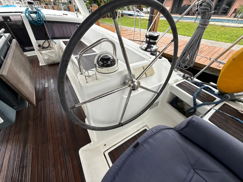Slide: The Image of Steering wheel of a 2012 Beneteau Oceanis 48 sailboat with wooden deck. - 15
