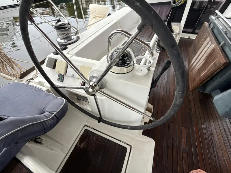 Slide: The Image of Steering wheel of 2012 Beneteau Oceanis 48 sailboat with wooden deck and nautical equipment. - 16