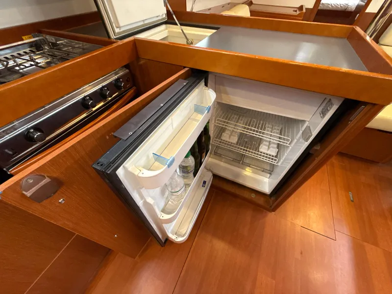 Slide: The Image of Interior of 2012 Beneteau Oceanis 48 yacht showing open fridge and stove in galley. - 19