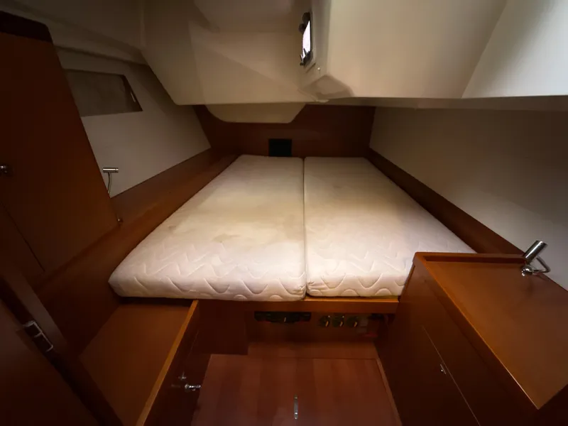 Slide: The Image of Cozy cabin interior of 2012 Beneteau Oceanis 48 yacht with double bed and wooden furnishings. - 23