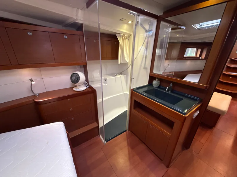 Slide: The Image of Interior of 2012 Beneteau Oceanis 48 yacht with wood finish, shower, and sink. - 28