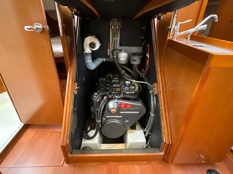 Slide: The Image of Engine compartment of a 2012 Beneteau Oceanis 48 sailboat, showcasing the motor and surrounding components. - 30