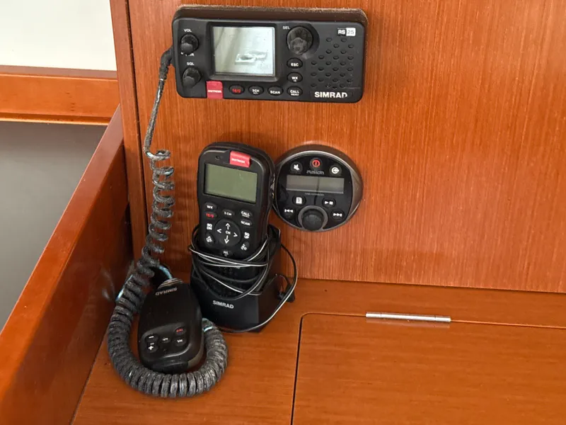 Slide: The Image of Simrad marine radio equipment on 2012 Beneteau Oceanis 48 yacht's wooden interior panel. - 32