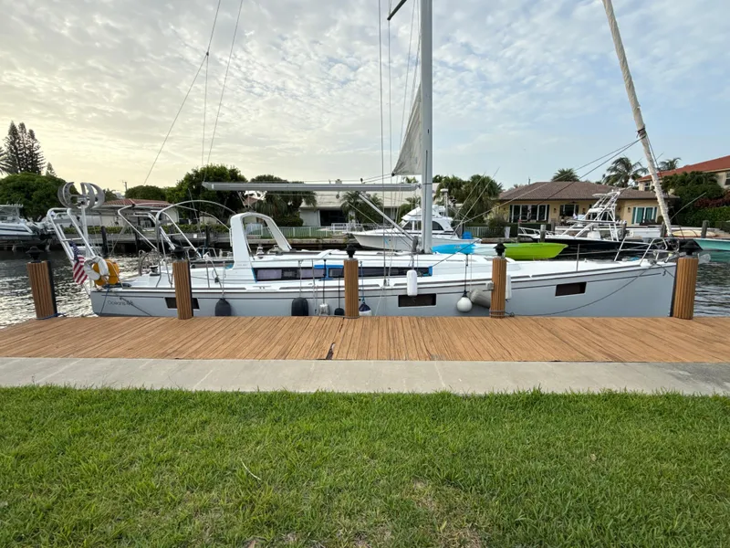 Slide: The Image of Beneteau Oceanis 48 sailboat docked by a wooden pier, 2012 model. - 4