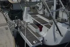 Slide: The Image of Beneteau Oceanis 48 (2012) yacht stern view at dock with boarding steps. - 5