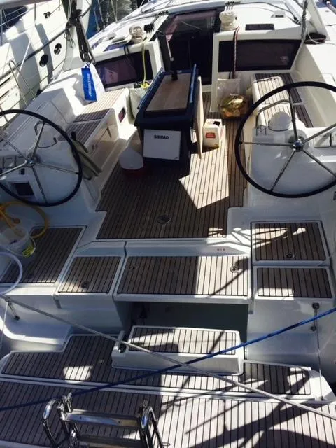 Slide: The Image of Beneteau Oceanis 48 2012 sailboat cockpit with dual steering wheels and teak decking. - 6