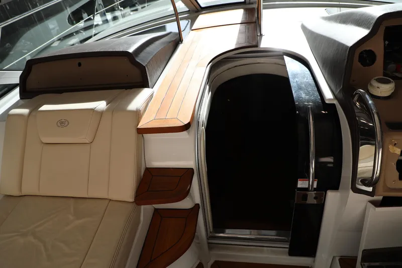Slide: The Image of Interior of a 2008 Cobalt 46 yacht with wooden steps and leather seating. - 10