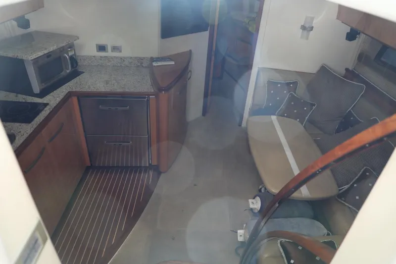 Slide: The Image of Interior of a 2008 Cobalt 46 yacht with kitchen and seating area. - 13