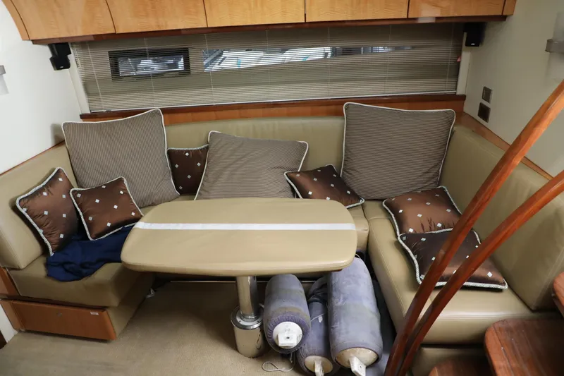 Slide: The Image of Interior of 2008 Cobalt 46 yacht with cushioned seating and table. - 14