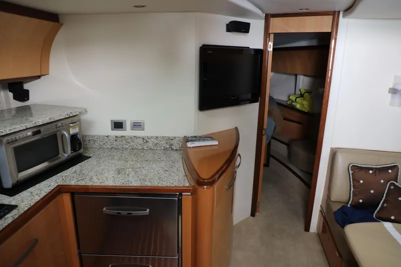 Slide: The Image of Interior of 2008 Cobalt 46 yacht with kitchen, TV, and seating area. - 15