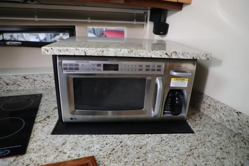 Slide: The Image of Built-in microwave in the kitchen of a 2008 Cobalt 46 yacht. - 16