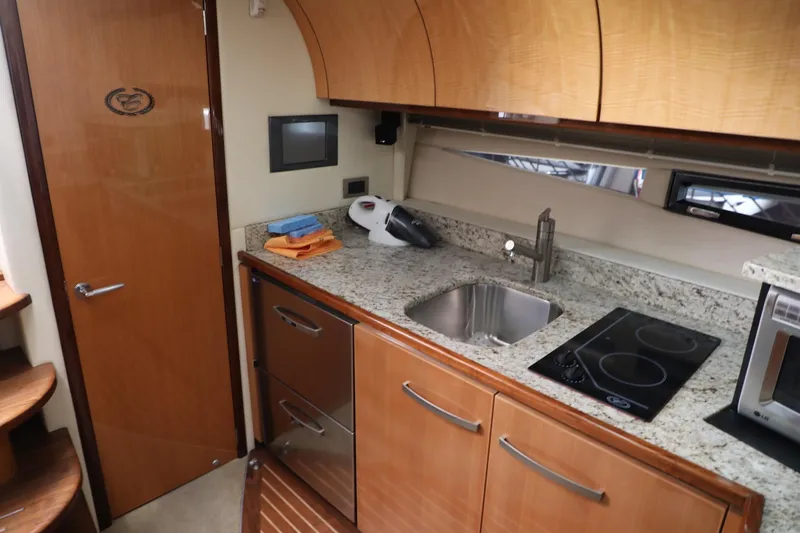 Slide: The Image of 2008 Cobalt 46 yacht kitchen with granite countertops, stainless steel sink, and electric stovetop. - 18
