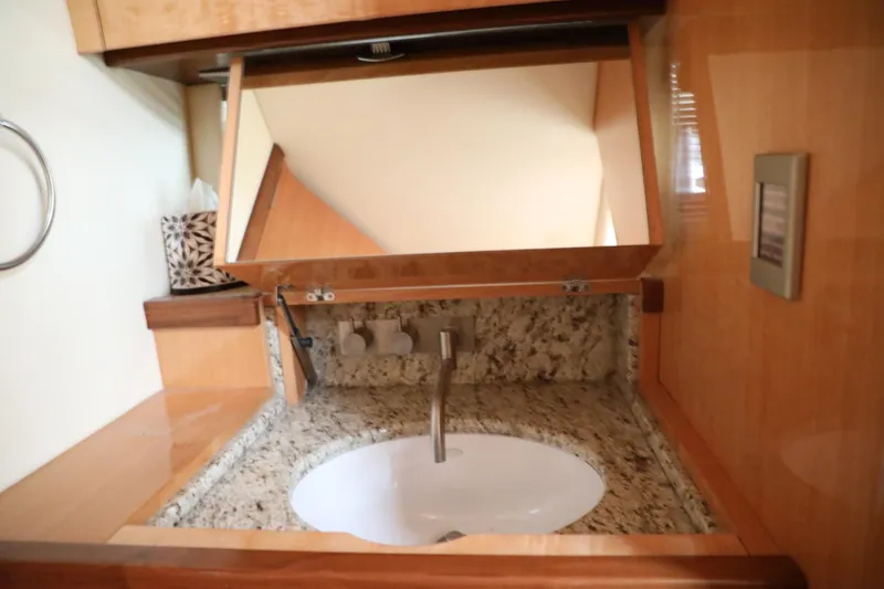 Slide: The Image of 2008 Cobalt 46 yacht bathroom sink with granite countertop and mirror. - 21