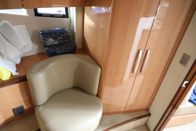 Slide: The Image of Interior of 2008 Cobalt 46 yacht with leather chair and wooden cabinets. - 28