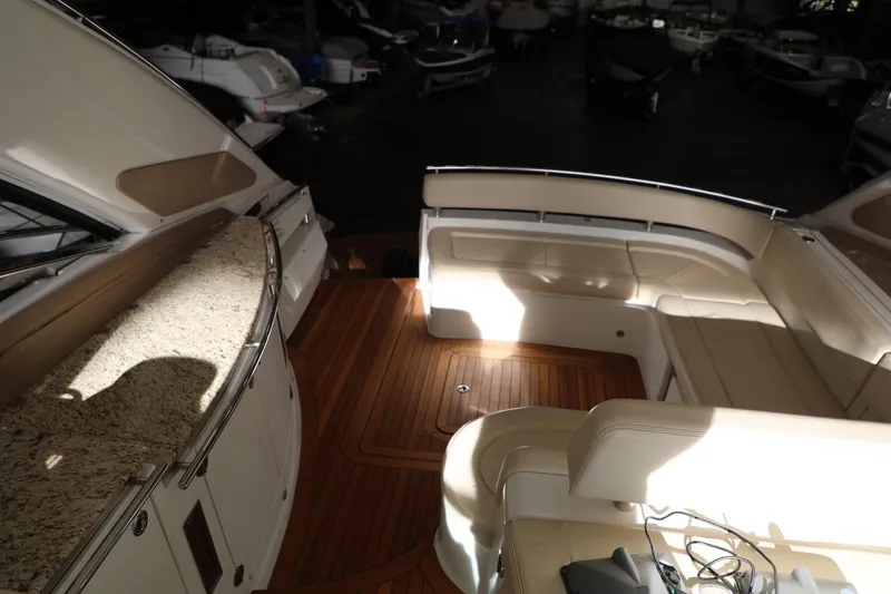 Slide: The Image of 2008 Cobalt 46 yacht interior with teak flooring and white leather seating. - 3
