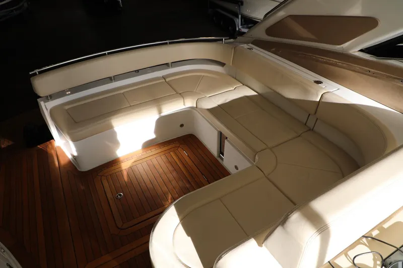 Slide: The Image of 2008 Cobalt 46 yacht with spacious beige seating and wooden deck. - 4