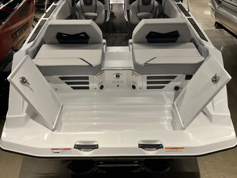 Slide: The Image of 2024 Scarab 235 ID boat interior with open storage compartments. - 10