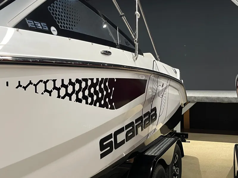 Slide: The Image of 2024 Scarab 235 ID boat with modern design and graphics. - 2
