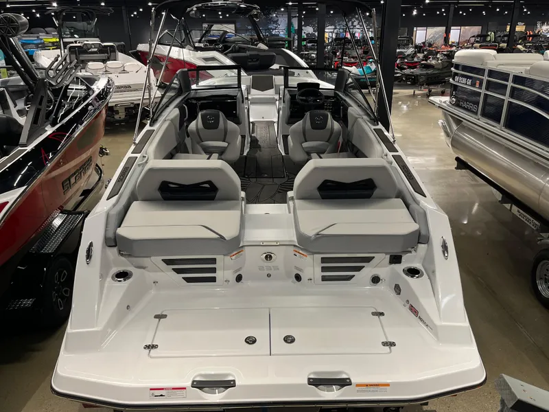 Slide: The Image of 2024 Scarab 235 ID boat interior with seating and dashboard in showroom. - 3