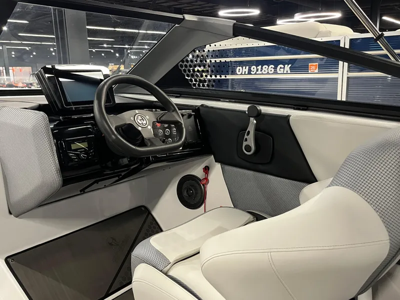 Slide: The Image of 2024 Scarab 235 ID boat interior with steering wheel and dashboard. - 4