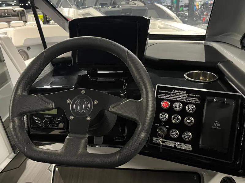 Slide: The Image of 2024 Scarab 235 ID boat dashboard with steering wheel and control panel. - 5
