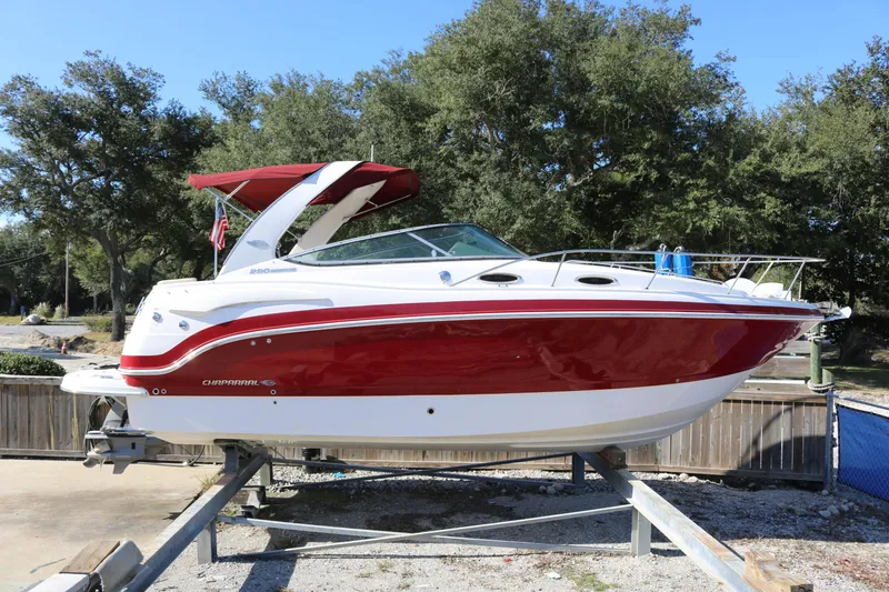The Image of 2016 Chaparral 290 Signature boat with red and white exterior on a trailer. - 0