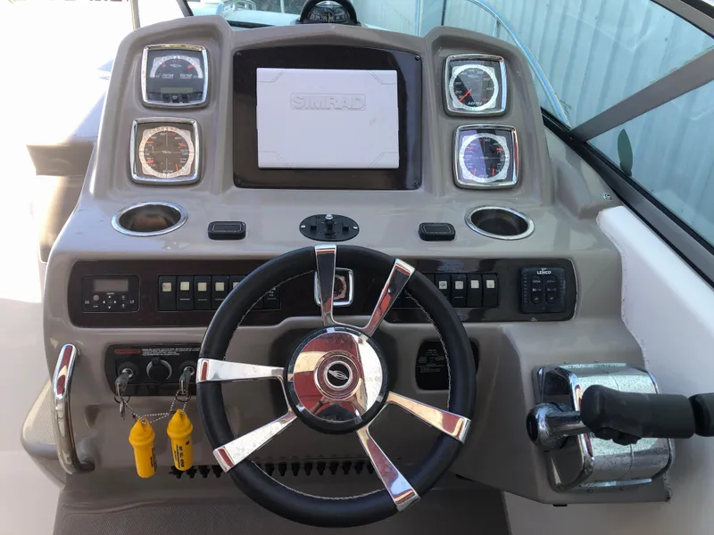Slide: The Image of Control panel of 2016 Chaparral 290 Signature boat with steering wheel and gauges. - 19