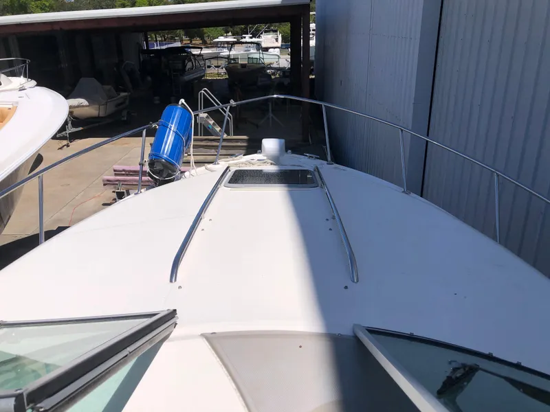 Slide: The Image of 2016 Chaparral 290 Signature boat docked, viewed from the bow, with marina background. - 21
