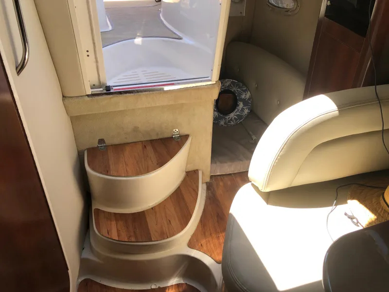 Slide: The Image of Interior of 2016 Chaparral 290 Signature boat with wooden steps and seating area. - 30