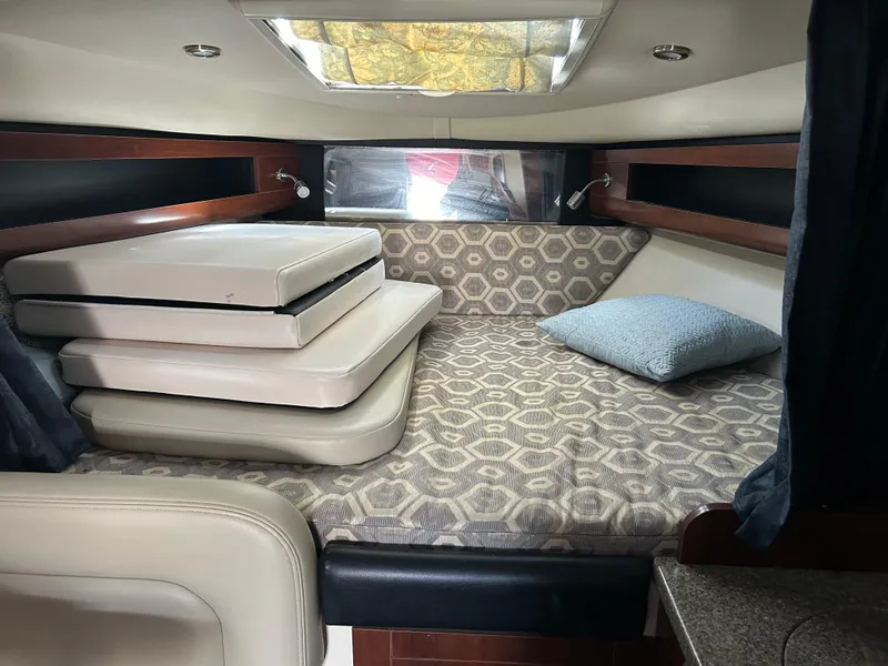 Slide: The Image of 2016 Chaparral 290 Signature cabin interior with patterned bedding and cushions. - 35