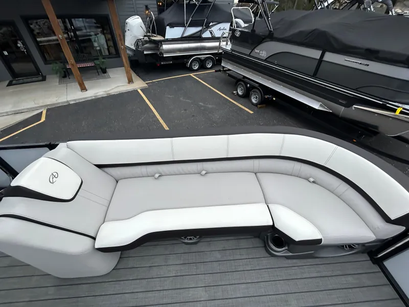 Slide: The Image of 2024 Avalon LSZ 2585 RL boat with luxurious seating in a showroom. - 11