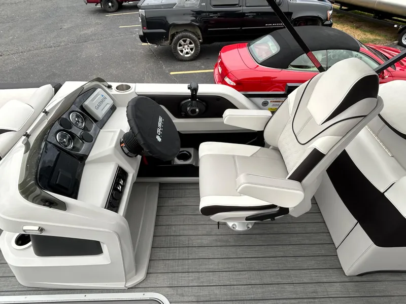 Slide: The Image of 2024 Avalon LSZ 2585 RL boat interior with captain's chair and dashboard. - 17