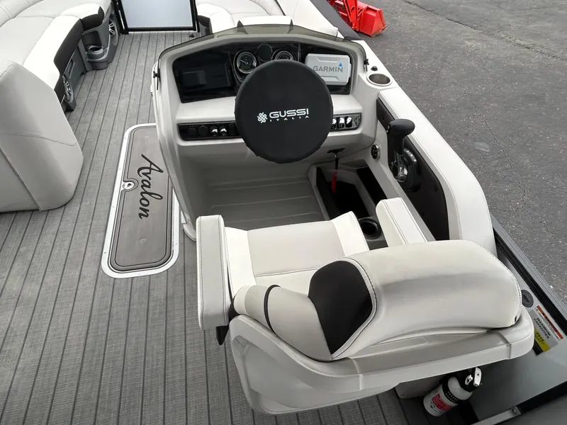 Slide: The Image of 2024 Avalon LSZ 2585 RL boat cockpit with Gussi Italia steering wheel and Garmin navigation. - 18